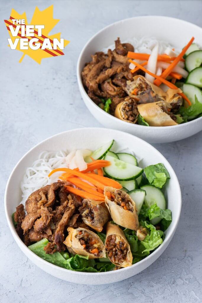 twp vermicelli bowls with spring rolls, noodles, pickled carrots and daikon, cucumber and lettuce