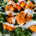 buffalo ranch tofu on a bed of massaged kale