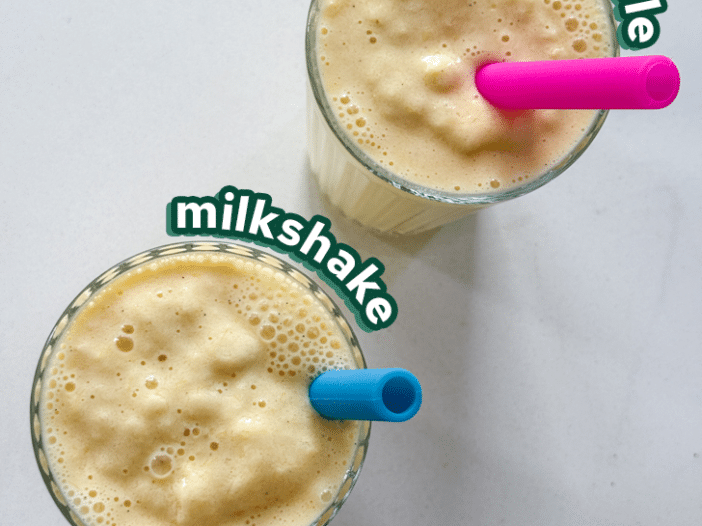 vegan orange cream milkshake in two glasses with colourful silicone straws